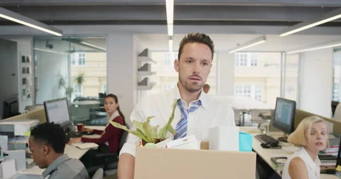 Businessman getting fired carrying box of personal belongings being made Stock Footage