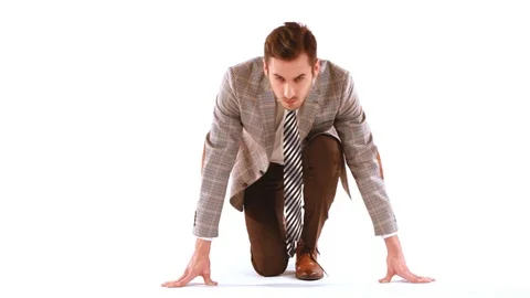 Businessman getting ready to start and raises his head Stock-Footage 72031568