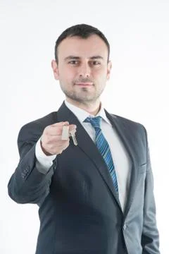 Businessman give metal home key Stockfoto's