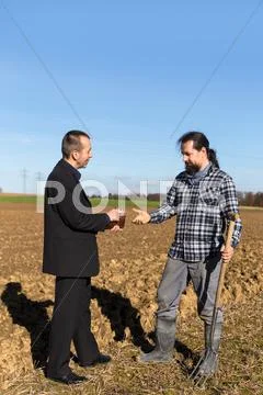 Businessman is giving money to a farmer Stock Photos