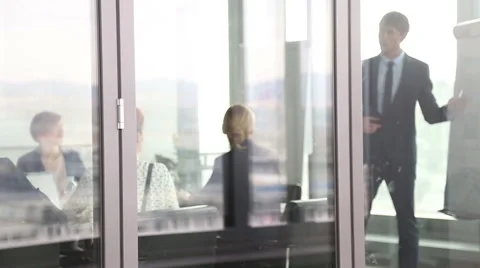 Businessman giving presentation using flipchart behind glass wall Stock Footage 59544248