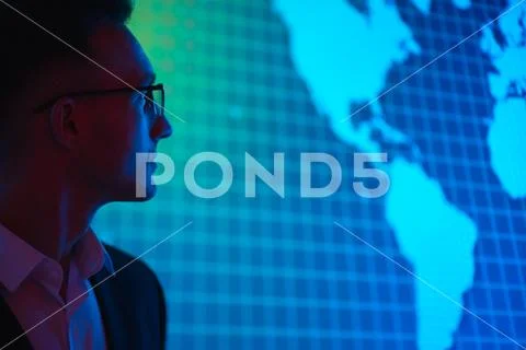 The businessman in glasses standing near big display Stock Photos