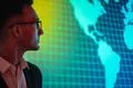 The businessman in glasses standing near big display Photo