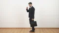 The businessman in glasses walking with a bag on the white wall background 4k or 4k+ Resolution