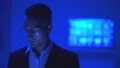 The businessman in glasses working in the dark room 4k or 4k+ Resolution