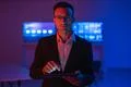 The businessman in glasses working with a tablet in the dark room Photo