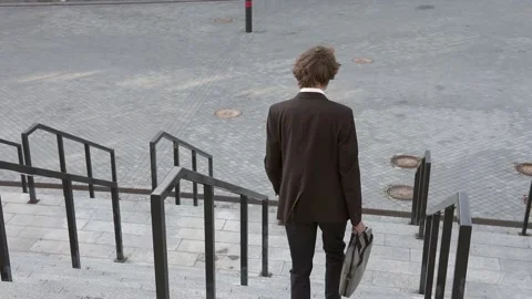 A businessman is going down the work stairs. Stock Footage 228954185