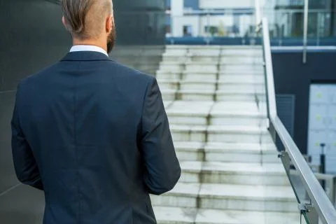 Businessman going to his work. Back view. Stock Photos