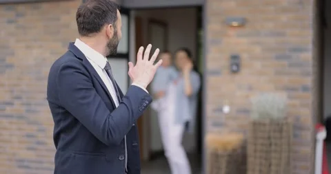 Businessman going out at work saying goodbye to his family at the doorway 動画素材 154648239