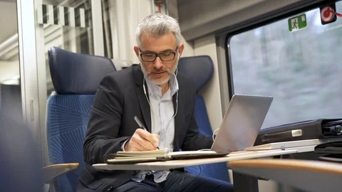 Businessman going to work by train, talking on phone Stock-Footage 103287394
