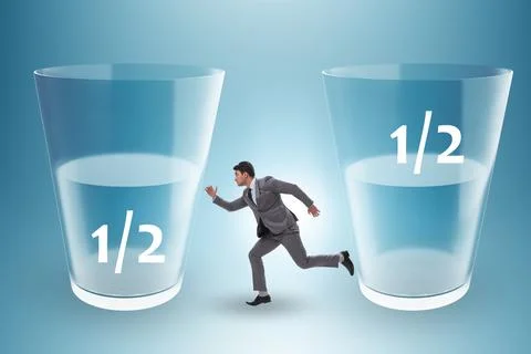 Businessman in half empty half full glass concept Stock Photos