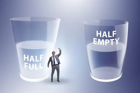 Businessman in half empty half full glass concept Stock Photos