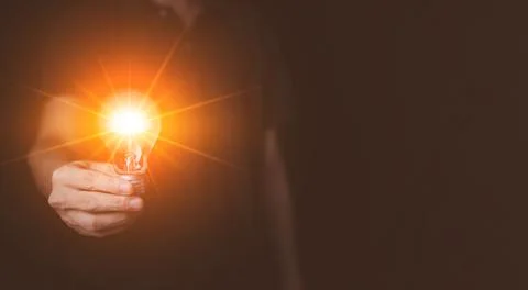 Businessman hand hold Virtual lightbulb. New ideas inspiration and innovati.. Stock Photos