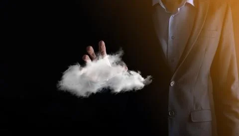 Businessman hand holding cloud.Cloud computing concept, close up of young bus Stock Photos