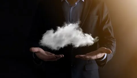 Businessman hand holding cloud.Cloud computing concept, close up of young bus Stock Photos