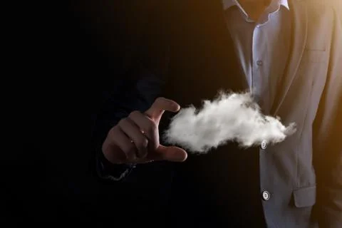 Businessman hand holding cloud.Cloud computing concept, close up of young bus Stock Photos