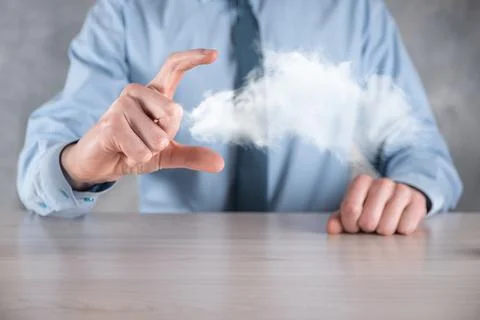 Businessman hand holding cloud.Cloud computing concept, close up of young bus Stock Photos