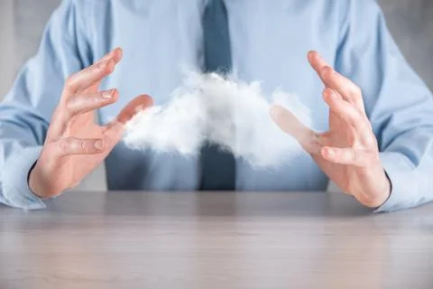 Businessman hand holding cloud.Cloud computing concept, close up of young bus Stock Photos
