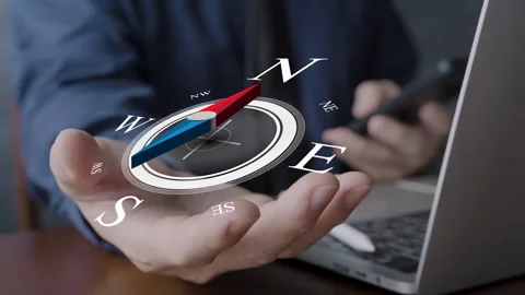 Businessman hand holding virtual compass symbol over laptop showing directio Stock Footage 319642220