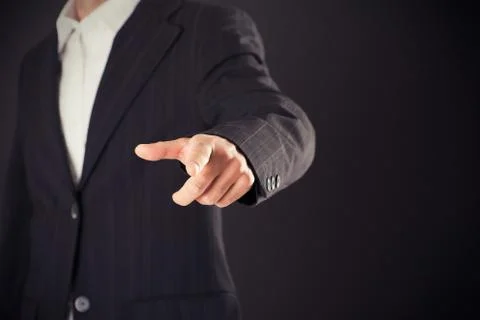 Businessman hand pointing on empty space on black background Stock Photos