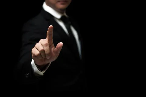 Businessman hand pointing on empty space on black background Foto stock