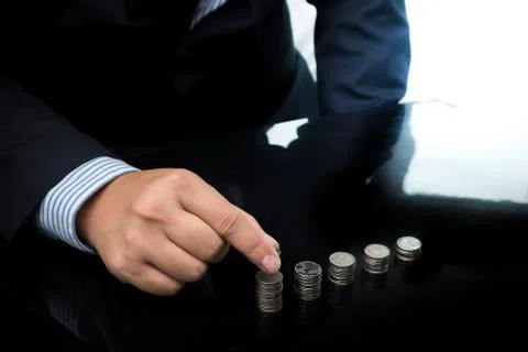 Businessman Hand Put Coins To Stack Of Coins Stock Photos