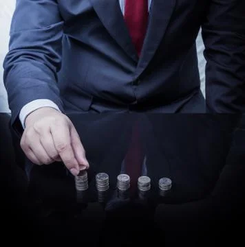 Businessman Hand Put Coins To Stack Of Coins Stock Photos
