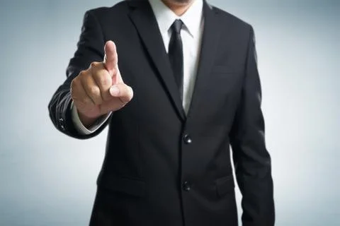 Businessman hand touching empty virtual screen, modern business background co Stock Photos