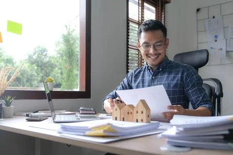 Businessman hand using calculator and working with laptop calculate about Stock Photos