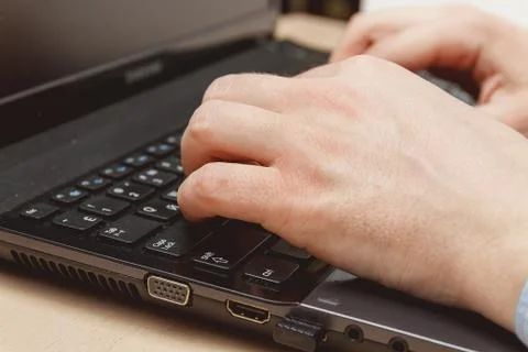 Businessman hand using keyboard on computer laptop Stock Photos