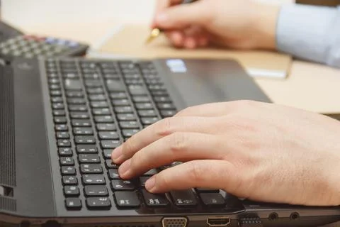 Businessman hand using keyboard on computer laptop Stock Photos