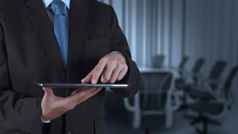 Businessman hand using tablet computer and board room Stock Illustration