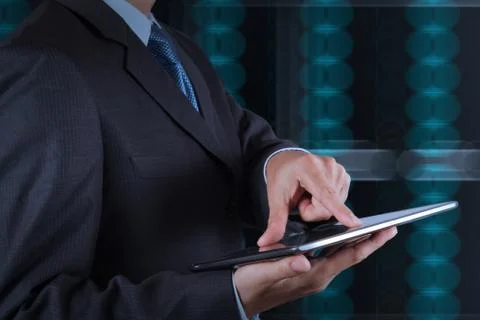 Businessman hand using tablet computer and server room background イラスト素材