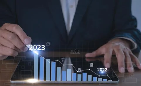 Businessman hand using tablet with creative glowing arrow and stock chart. Ha Stock Photos