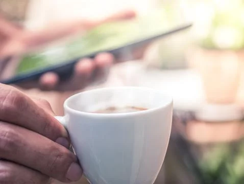 Businessman Hand Using Tablet For Working In Coffee Shop Stock Photos