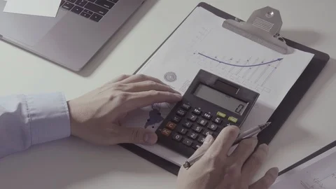 Businessman hand working with finances about cost and calculator Stock Footage