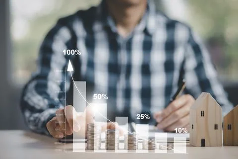 Businessman hand write in book note and icon business graphs with mini wood h Stock Photos