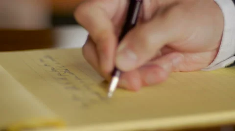Businessman hand writing letter in legal notebook with pen CLOSE UP Stock Footage