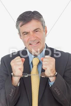Businessman with handcuffed hands Stock Photos