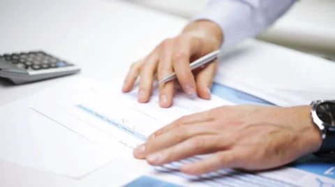 Businessman hands with calculator and papers Stock Footage