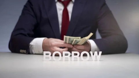 Businessman hands consider banknote from a bundle of money for borrow to partner Vídeo Stock 82704479