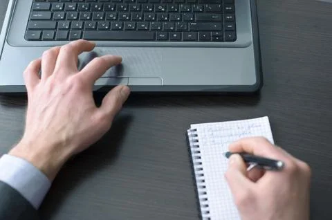 Businessman hands  doing some computer work Stock Photos