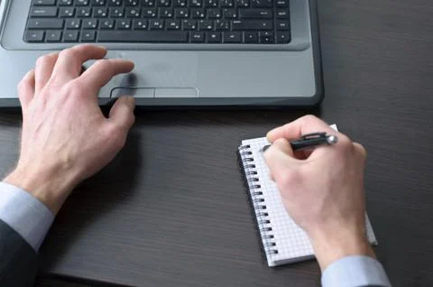Businessman hands  doing some computer work Stock Photos