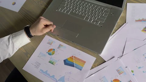 Businessman hands make notes on paper with graphs Stock Footage 110939299