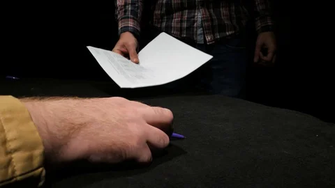 A businessman hands a signed document to another businessman. Video stock 129786684