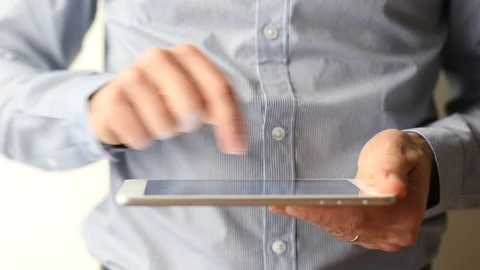 Businessman hands using a digital tablet computer, finger touching screen Stock Footage 92251173