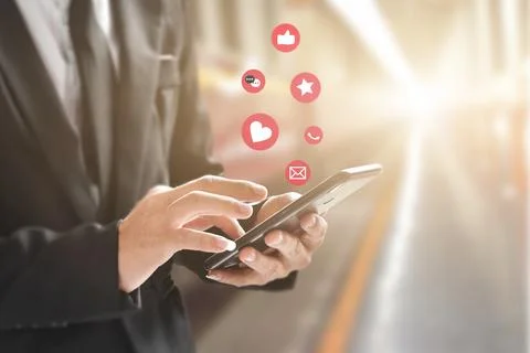 Businessman hands using mobile smartphone with icon social media and network  Stock Photos