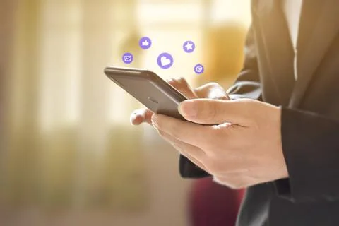 Businessman hands using mobile smartphone with icon social media and network  Stock Photos