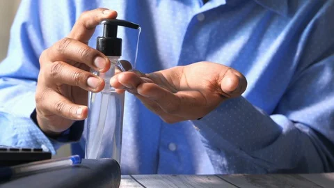 Businessman hands using wash hand sanitizer gel dispenser Stock Footage