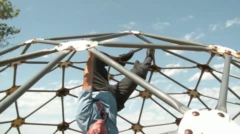 Businessman Hangs Upside Down at Playground Stock Footage